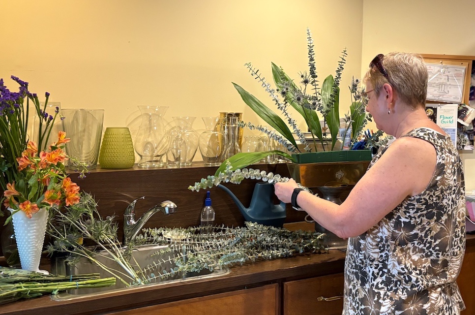 A member of the Flower Guild arranges flowers for a worship service.